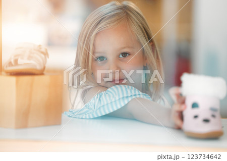 Girl child, retail shopping for shoes and choosing pink kids winter boots on shelf of childrens fashion shop. Portrait of young customer, toddler at clothes boutique in a mall and buying shoe on sale Girl child, retail shopping for shoes and choosing pink kids winter boots on shelf of childrens fashion shop. Portrait of young customer, toddler at clothes boutique in a mall and buying shoe on sale 123734642