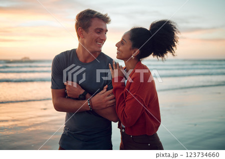 Summer, love and couple at a beach on vacation, bonding and laughing while walking along the sea at sunset. Freedom, nature and travel by happy and relax man and woman enjoying romantic ocean walk 123734660