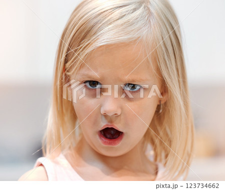 Angry, little girl and tantrum face portrait reaction to shock of rejection and disappointment. Unhappy, frustrated and moody female child with bad attitude and annoyed eyes closeup in Canada. 123734662