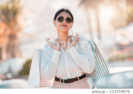 Shopping, wealth and woman on smile for fashion discount, promotion and sales deal in retail market. Freedom, smile and customer or latino female walking with bags of clothes outdoor in Paris, France Shopping, wealth and woman on smile for fashion discount, promotion and sales deal in retail market. Freedom, smile and customer or latino female walking with bags of clothes outdoor in Paris, France 123734679