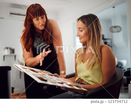 Salon, hair and and beauty with a woman customer at the hairdresser with a stylist choosing a color. Fashion, studio and client with a young female getting a haircut in a professional boutique 123734712