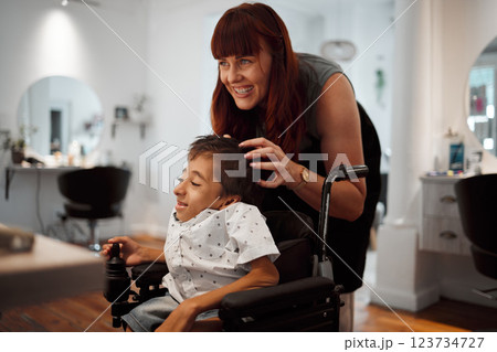 Woman, salon and smile with disability child in wheelchair for haircut. Happy, boy and girl hairdresser for cleaning, cut and styling cerebral palsy kid hair at professional barber store in New York Woman, salon and smile with disability child in wheelchair for haircut. Happy, boy and girl hairdresser for cleaning, cut and styling cerebral palsy kid hair at professional barber store in New York 123734727