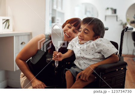 Woman, child disability and mirror in salon for self love happy with service after barber, hairdresser or stylist cuts hair. Disabled, cerebral palsy and handicap or special needs boy in wheelchair. 123734730