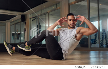Athlete, man and side sit up with exercise at gym for core strength, muscle growth and body balance. Active, male person and bicycle crunches with fitness training, sports workout and ab development 123734738