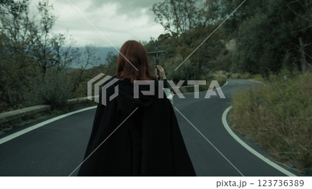 Religious Woman Walks In Street Esoteric Procession With Jesus Crucifix In Hand 123736389