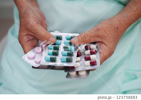 Asian elderly woman holding pill drug in hand, strong healthy medical. Asian elderly woman holding pill drug in hand, strong healthy medical. 123738883