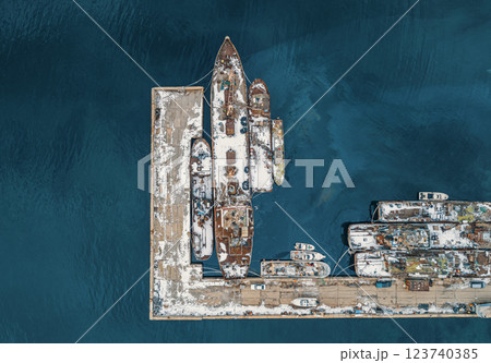 Abandoned vessels docked at a quiet harbor under a cloudy sky in early morning light 123740385