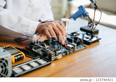 The technician repairing the motherboard in the lab with copy space. the concept of computer hardware, The technician repairing the motherboard in the lab with copy space. the concept of computer hardware, 123740421