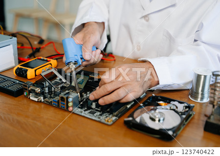 The technician repairing the motherboard in the lab with copy space. the concept of computer hardware, The technician repairing the motherboard in the lab with copy space. the concept of computer hardware, 123740422