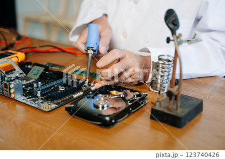 The technician repairing the motherboard in the lab with copy space. the concept of computer hardware, The technician repairing the motherboard in the lab with copy space. the concept of computer hardware, 123740426