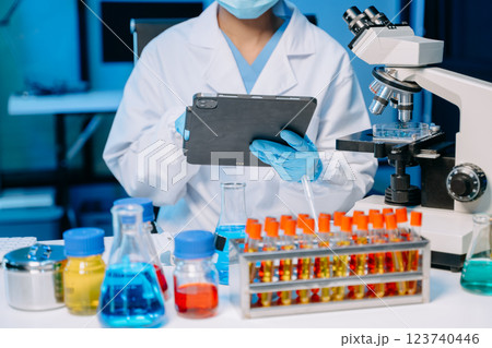 Modern medical research laboratory. female scientist hands working with micro pipettes analyzing biochemical samples 123740446