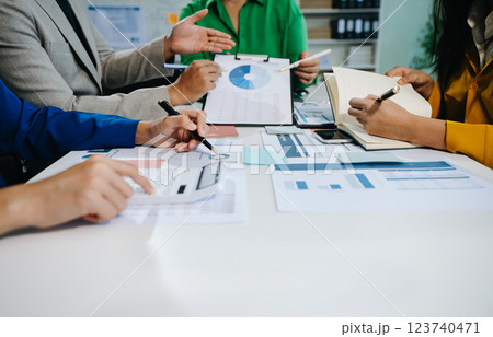 The business team analyzes revenue charts and graphs with laptop and tablet. The business team analyzes revenue charts and graphs with laptop and tablet. 123740471