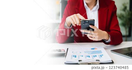 Confident businessman working on laptop,tablet and smartphone at her workplace at office Confident businessman working on laptop,tablet and smartphone at her workplace at office 123740485