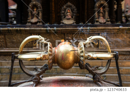 A Golden Vajra the symbol of Indra weapon (Kings of god in Hindu and Buddhism religion) in the golden temple of Patan, Lalitpur city in Nepal. A Golden Vajra the symbol of Indra weapon (Kings of god in Hindu and Buddhism religion) in the golden temple of Patan, Lalitpur city in Nepal. 123740633