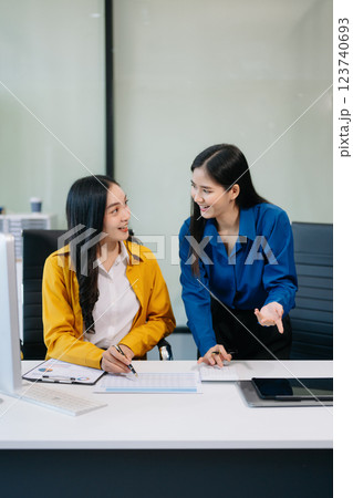 Businesswomen work and discuss their business plans. A woman employee explains Businesswomen work and discuss their business plans. A woman employee explains 123740693