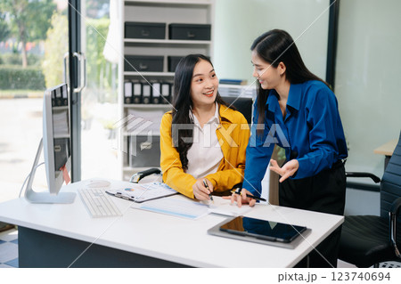 Businesswomen work and discuss their business plans. A woman employee explains Businesswomen work and discuss their business plans. A woman employee explains 123740694