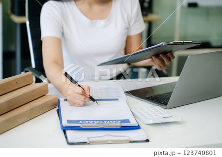 Confident businessman working on laptop, tablet and smartphone at her workplace 123740801