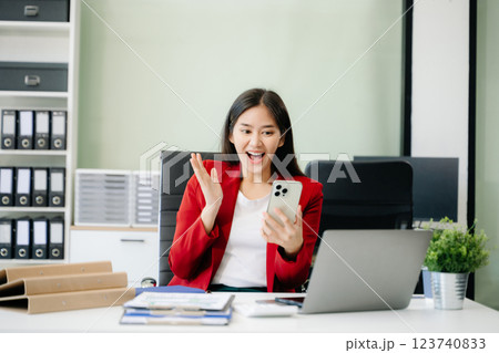 Business woman using tablet and laptop for doing math finance on an office desk, tax, 123740833