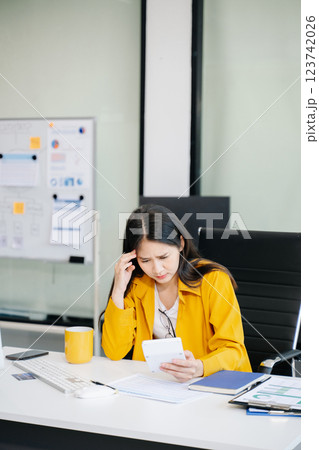 Asian business woman is stressed, bored, and overthinking from working Asian business woman is stressed, bored, and overthinking from working 123742026