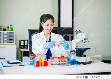 Scientists, beakers, and microscopes in cutting-edge research. Perfect for science and technology projects. 123742027