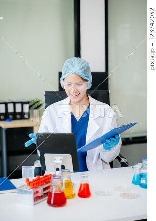 female scientist working with micro pipettes analyzing biochemical 123742052