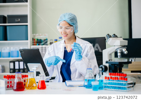 female scientist working with micro pipettes analyzing biochemical female scientist working with micro pipettes analyzing biochemical 123742072
