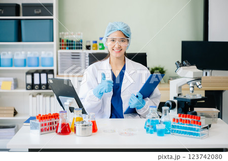 female scientist working with micro pipettes analyzing biochemical 123742080