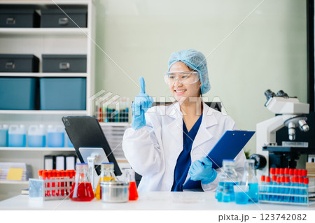 female scientist working with micro pipettes analyzing biochemical 123742082