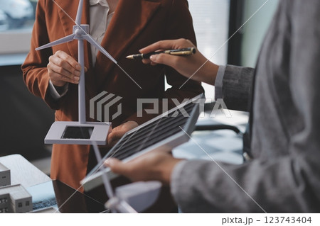 Discussion among businesspeople on the latest developments in solar cell panel technology and Solar Energy Environment city Concept. 123743404