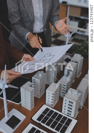 Discussion among businesspeople on the latest developments in solar cell panel technology and Solar Energy Environment city Concept. 123743407