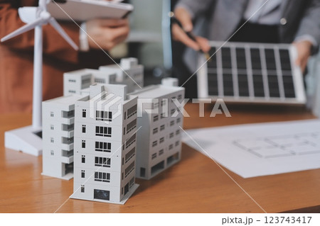 Discussion among businesspeople on the latest developments in solar cell panel technology and Solar Energy Environment city Concept. Discussion among businesspeople on the latest developments in solar cell panel technology and Solar Energy Environment city Concept. 123743417