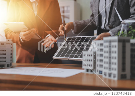 Discussion among businesspeople on the latest developments in solar cell panel technology and Solar Energy Environment city Concept. Discussion among businesspeople on the latest developments in solar cell panel technology and Solar Energy Environment city Concept. 123743418