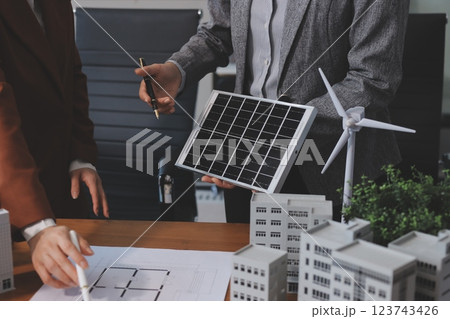 Discussion among businesspeople on the latest developments in solar cell panel technology and Solar Energy Environment city Concept. Discussion among businesspeople on the latest developments in solar cell panel technology and Solar Energy Environment city Concept. 123743426