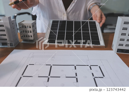 Discussion among businesspeople on the latest developments in solar cell panel technology and Solar Energy Environment city Concept. 123743442