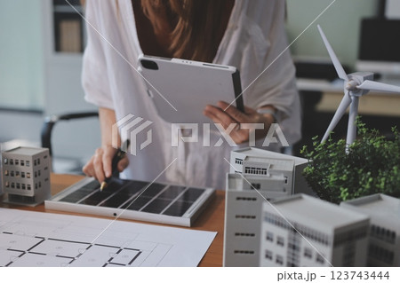 Discussion among businesspeople on the latest developments in solar cell panel technology and Solar Energy Environment city Concept. Discussion among businesspeople on the latest developments in solar cell panel technology and Solar Energy Environment city Concept. 123743444