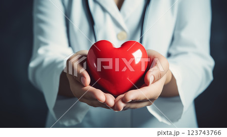 doctor holding a red heart in his hands. hands hold a red heart 123743766
