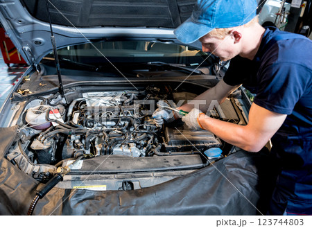 Car mechanic repair engine at service station. Car repair Car mechanic repair engine at service station. Car repair 123744803
