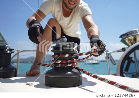 A man in a white hat is working on a voyage boat A man in a white hat is working on a voyage boat 123744867