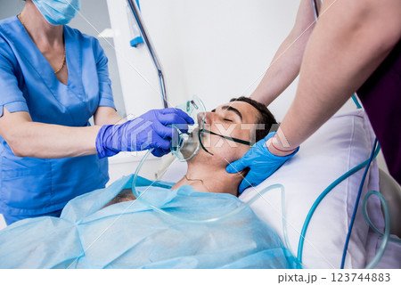 Doctors give resuscitation to a male patient in the emergency room. 123744883