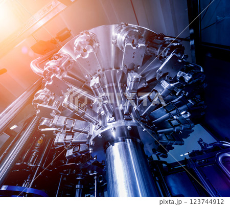 Automatic filling machine pours water into plastic PET bottles. 123744912