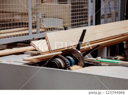 Production line of the wooden floor factory. CNC automatic woodworking machine. Production line of the wooden floor factory. CNC automatic woodworking machine. 123744966