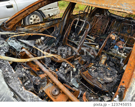 Charred remnants of a vehicle interior left behind after a devastating fire incident 123745055