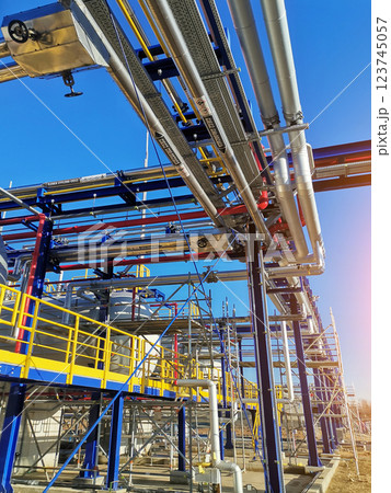 Steel structure is under construction on the construction site against a blue sky backdrop Steel structure is under construction on the construction site against a blue sky backdrop 123745057