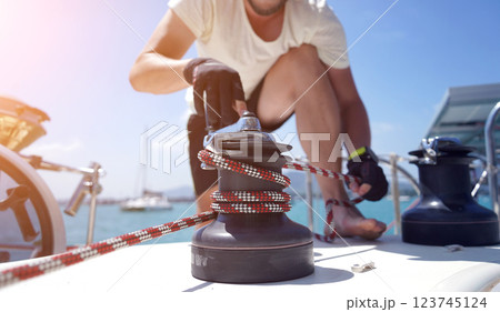 A man in a white hat is working on a voyage boat A man in a white hat is working on a voyage boat 123745124
