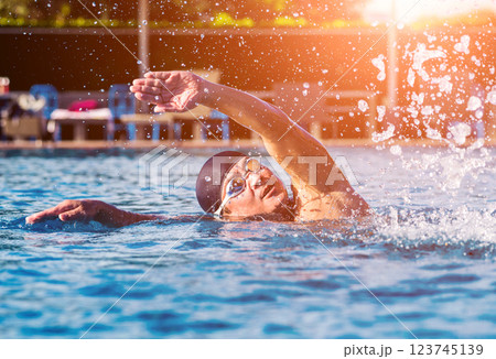 Young athletic man swimming in the swimming pool 123745139