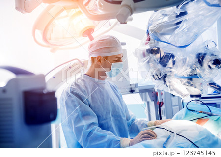 Spinal surgery. Group of surgeons in operating room with surgery equipment.  123745145