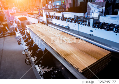 Production line of the wooden floor factory. CNC automatic woodworking machine. 123745177