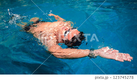 Young athletic man swimming in the swimming pool 123745278