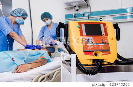 Doctors give resuscitation to a male patient in the emergency room. 123745296