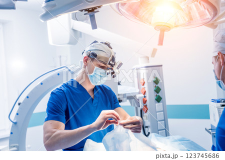 Spinal surgery. Group of surgeons in operating room with surgery equipment.  123745686